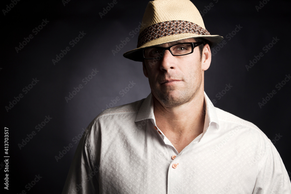 Man looking away while standing against black background Man looking away while standing against black background