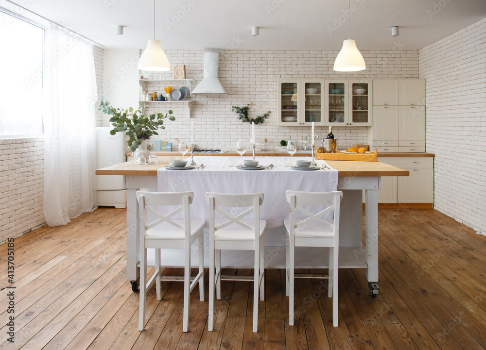 White kitchen with brick wall. Shelf with grocery products. Beautifully served family dining ...