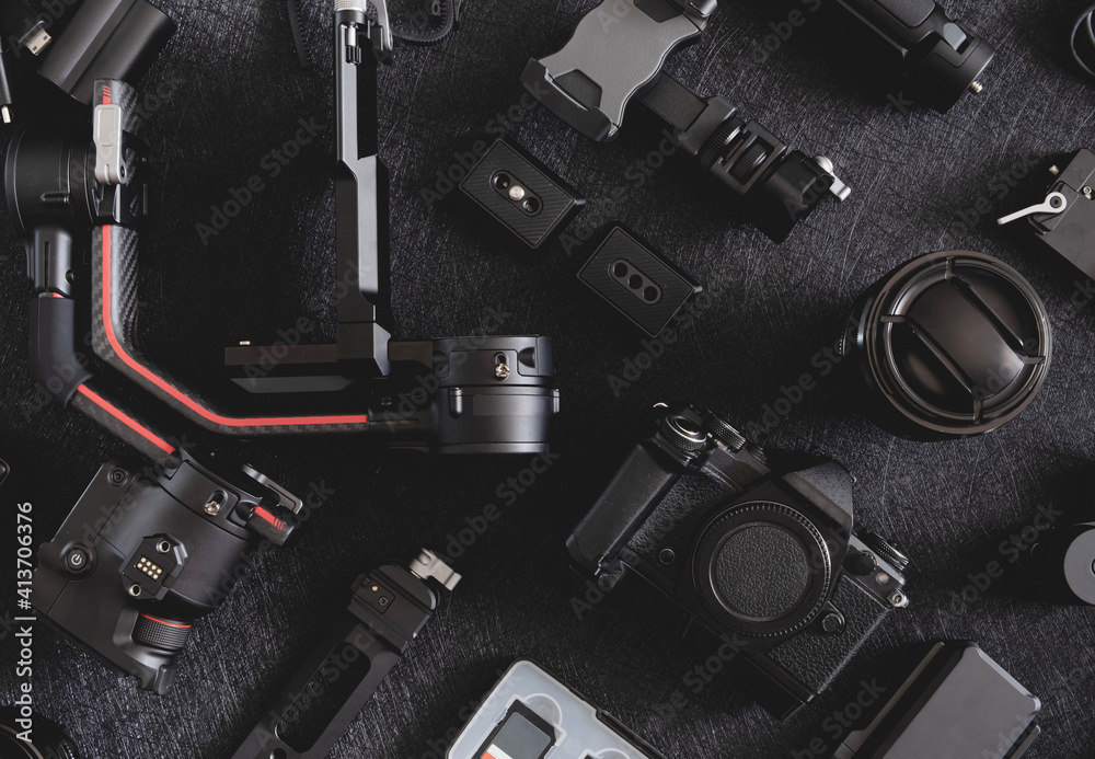 top view of work space photographer with digital camera, Gimbal Stabilizers and camera accessory top view of work space photographer with digital camera, Gimbal Stabilizers and camera accessory