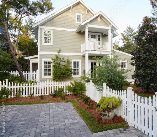 Plants growing by fence outside luxury beach cottage