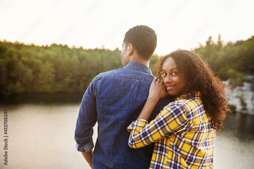 Portrait of woman standing with man at lakeshore Portrait of woman standing with man at lakeshore