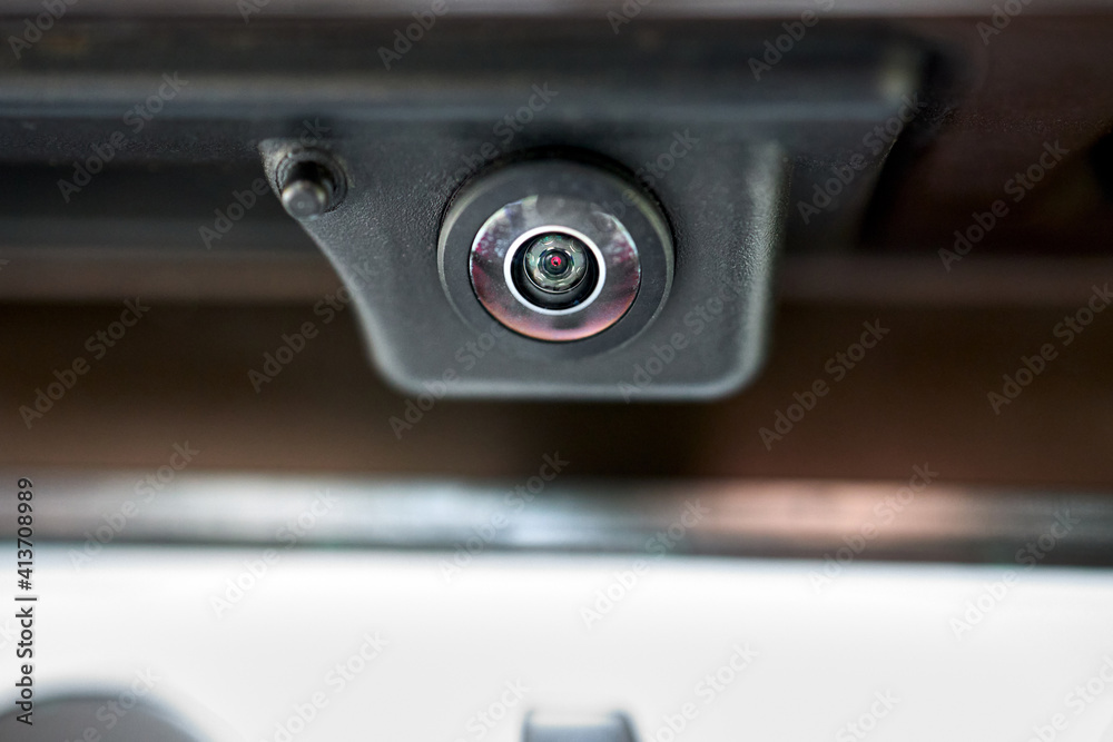 Luxury back car rear view camera close up for parking assistance in macro. Concept of safety car driving while parking process. Assist device equipment in modern cars