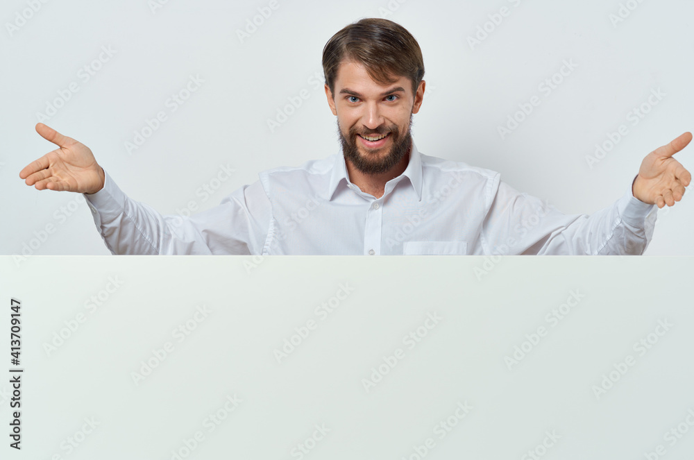 man peeking out from behind banner advertising lifestyle light background man peeking out from behind banner advertising lifestyle light background
