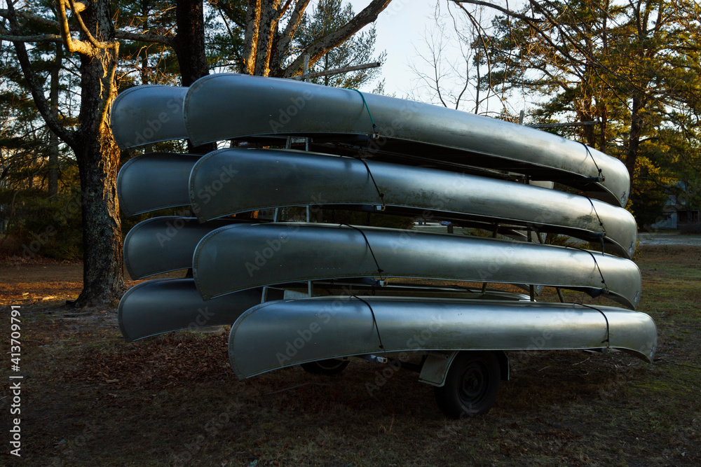 Canoes stacked upside down on field