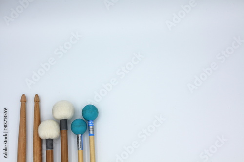 Fototapeta Percussion mallets set on a white background with space for text.
