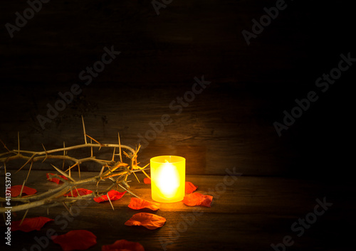 thorns candle and rose petals christian symbol photo