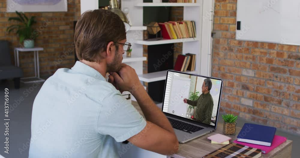 Caucasian male student using laptop on video call with male teacher