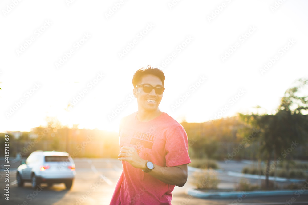 Man in sunglasses standing in parking lot against clear sky during sunset Man in sunglasses standing in parking lot against clear sky during sunset