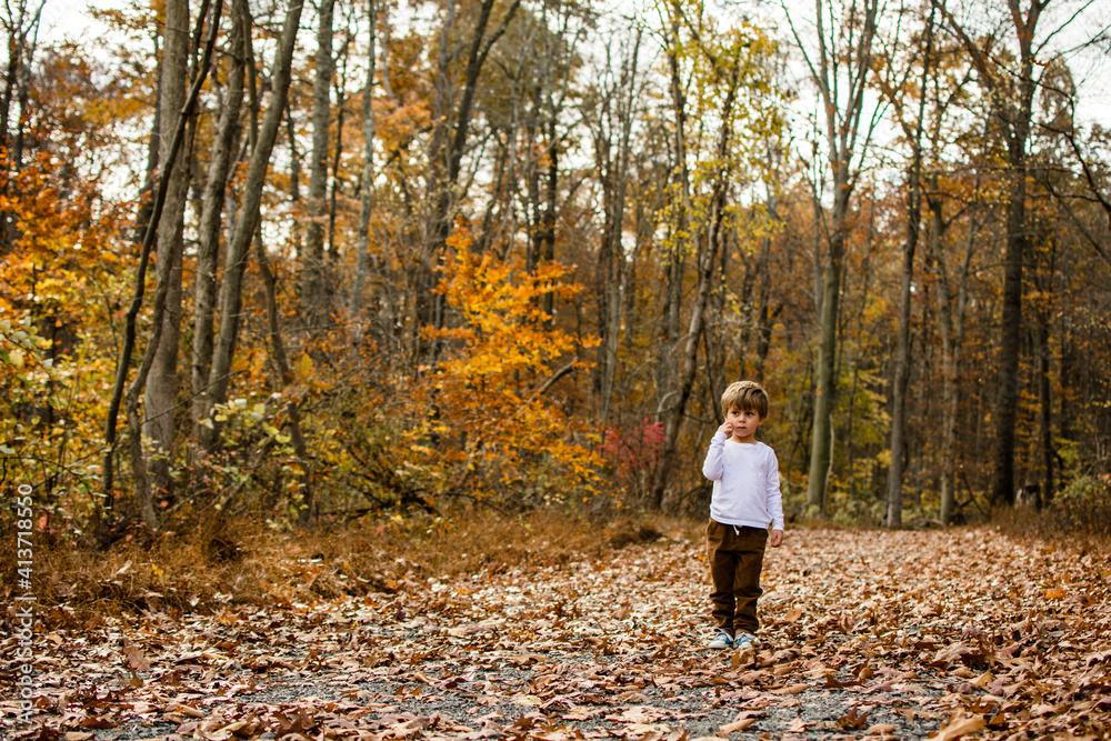 Boy looking away while standing on field Boy looking away while standing on field