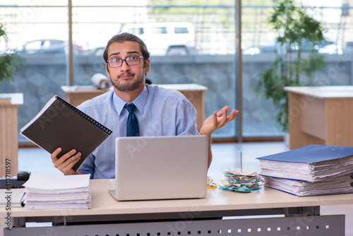 Young male accountant working in the office © Elnur