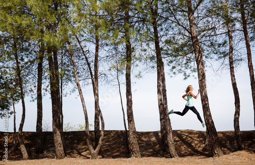 Wallpaper Mural Woman jogging on field amidst trees Torontodigital.ca