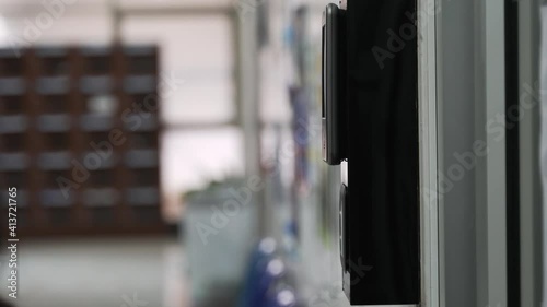 A hand using the key card on a scanner for the identification or entering the door