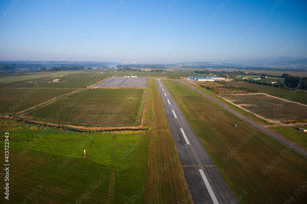 Aerial view of runway amidst field against sky Aerial view of runway amidst field against sky