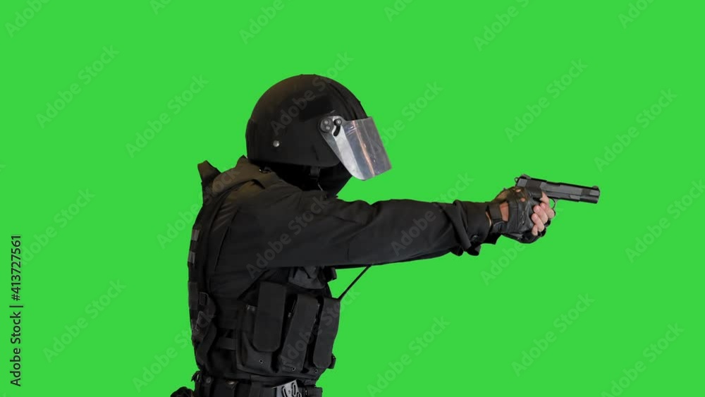 Swat agent running and aiming with a gun on a Green Screen, Chroma Key. Swat agent running and aiming with a gun on a Green Screen, Chroma Key.