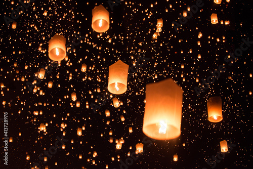 Low angle view of illuminated lanterns against sky at night