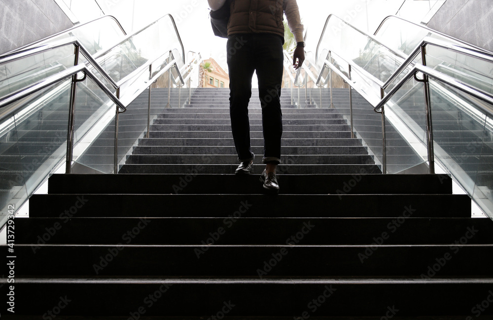 Low section of man on steps at subway station Low section of man on steps at subway station