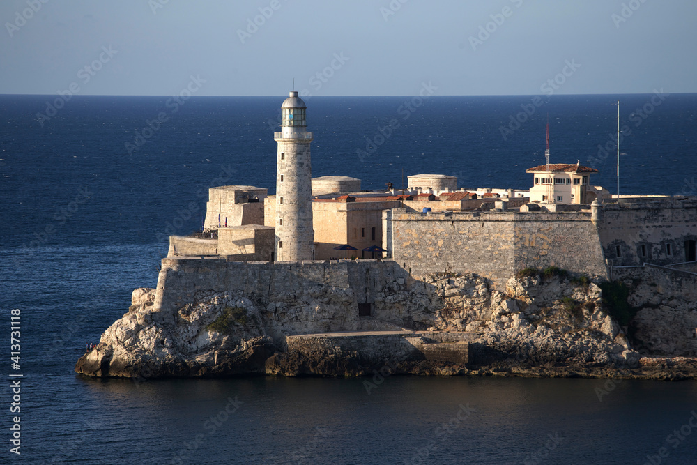 Lighthouse by buildings over sea against clear sky Lighthouse by buildings over sea against clear sky