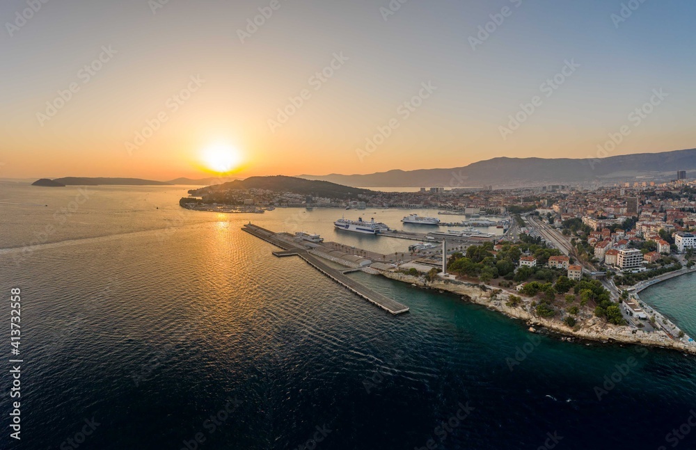 Aerial drone shot view of Split Ferry Port with sunset over horizon in summer Croatia
