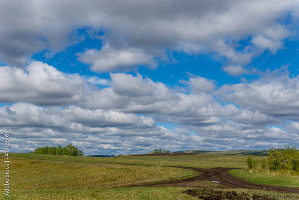 Spring fields on a sunny cloudy day