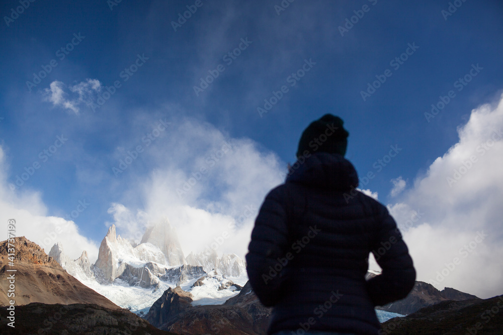 Rear view of woman standing against cloudy sky Rear view of woman standing against cloudy sky