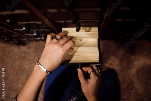 Overhead view of woman taking library cards from drawer photo