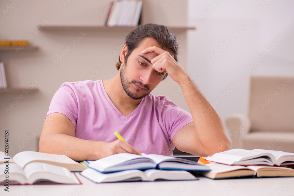 Young male student preparing for exams at home Young male student preparing for exams at home