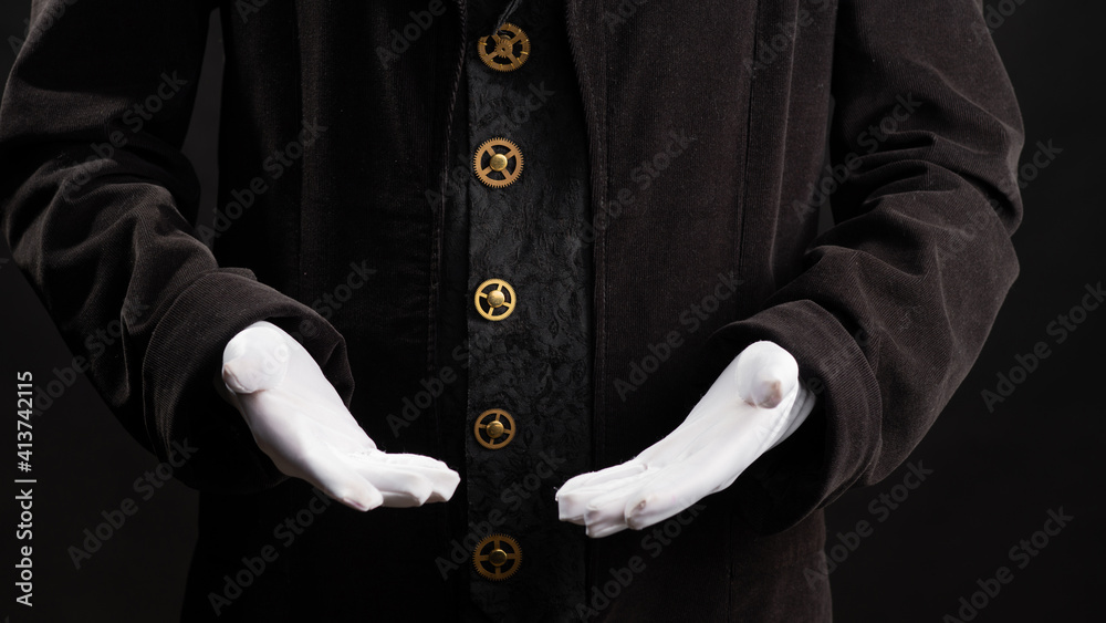 Hand gestures. Showman or magician illusionist in white gloves on a black background. Hand gestures. Showman or magician illusionist in white gloves on a black background.