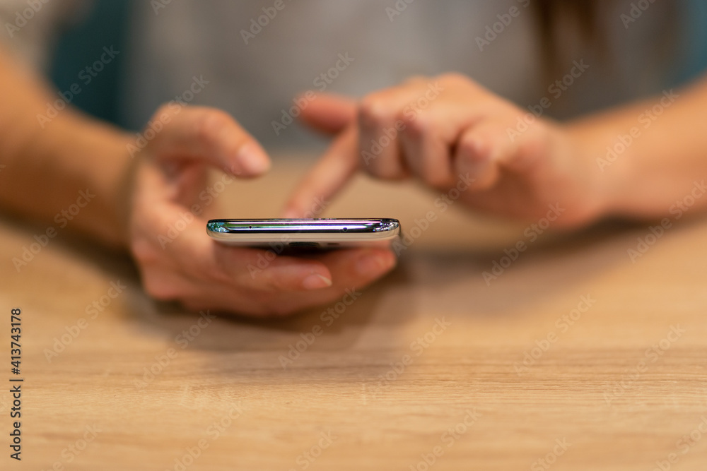woman sits at a table and uses her smartphone to plot a route or search for information on the Internet. woman sits at a table and uses her smartphone to plot a route or search for information on the Internet.