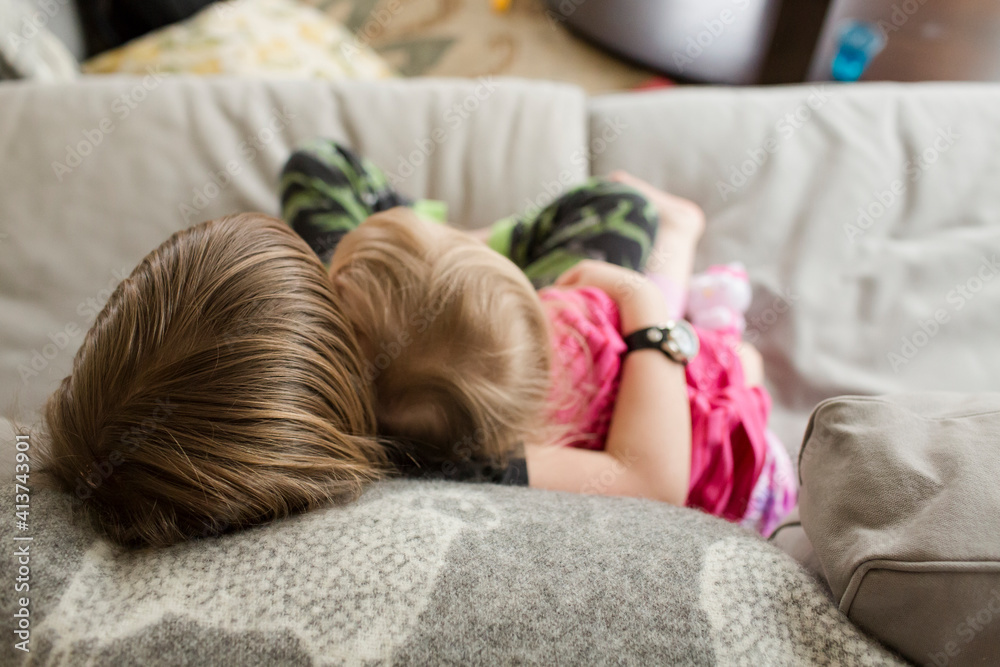 High angle view of boy embracing sister while relaxing on sofa at home High angle view of boy embracing sister while relaxing on sofa at home