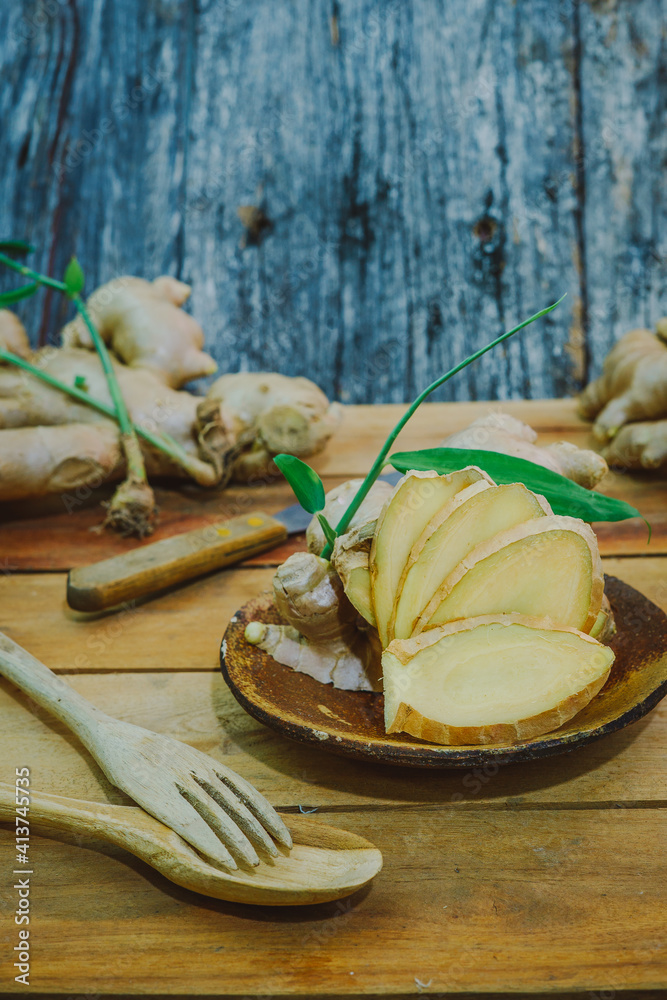 Fototapeta premium Fresh ginger root on the wooden table