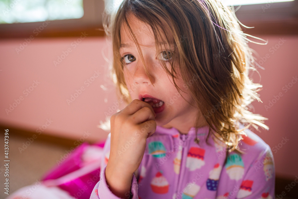 Portrait of girl touching tooth at home Portrait of girl touching tooth at home