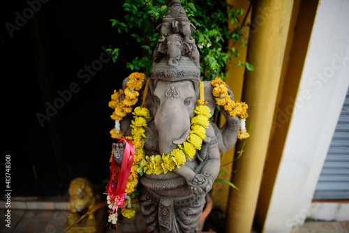 High angle view of Ganesha statue with floral garland