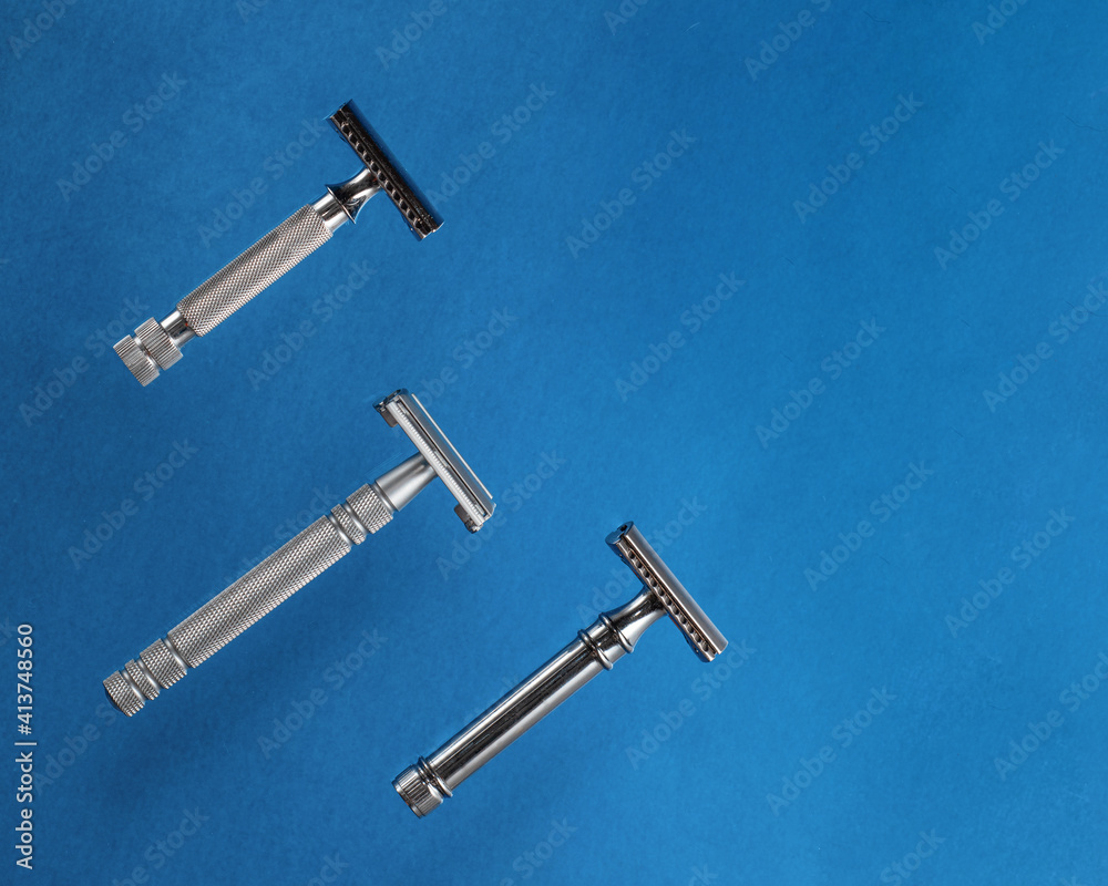 three razors on blue background. View from above. three razors on blue background. View from above.
