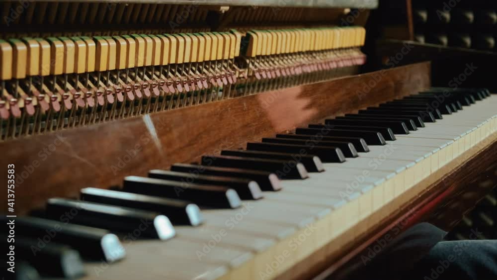 Beautiful playing the piano in the studio close-up general plan. Hands playing the piano. Beautiful playing the piano in the studio close-up general plan. Hands playing the piano.