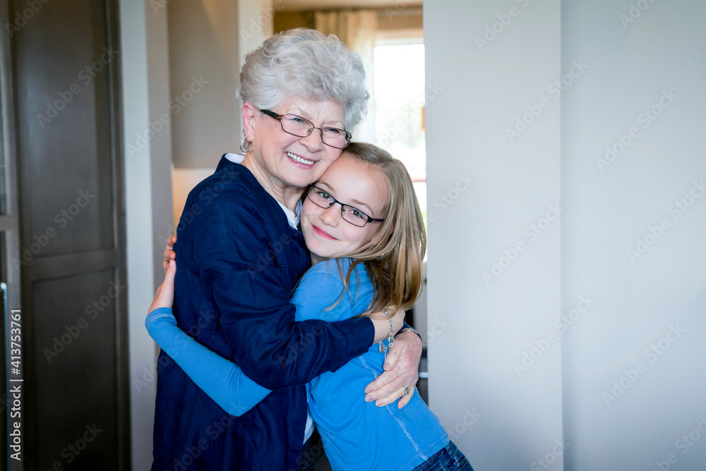Portrait of granddaughter embracing grandmother at home Portrait of granddaughter embracing grandmother at home