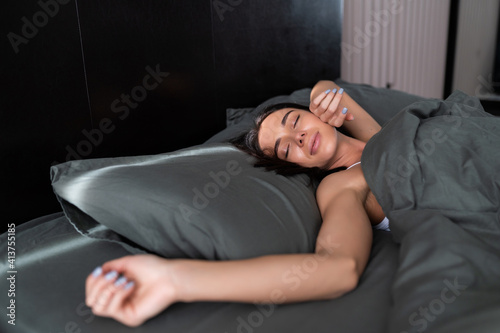 Young smiling pretty lady lies in bed indoors. © F8  \ Suport Ukraine