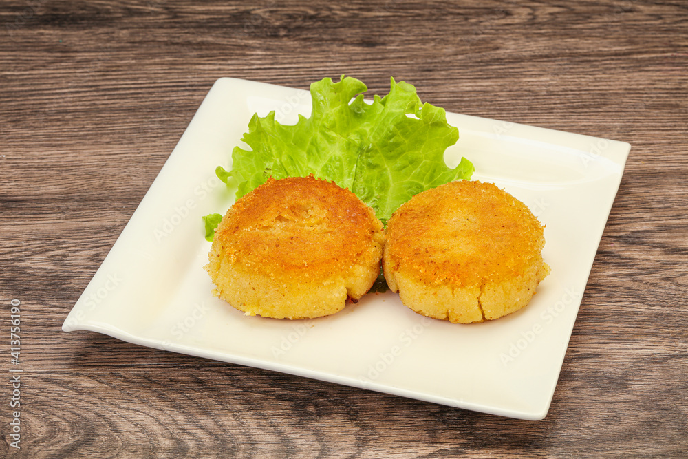 Vegan cuisine - Potato cutlet in the plate Vegan cuisine - Potato cutlet in the plate