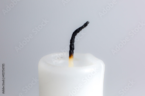 Картината върху платно Extinguished white candle on gray background