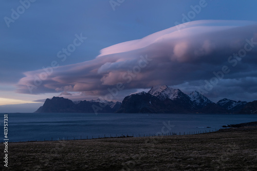 Lenticular clouds float over mountains of Vestvågøy, Lofoten Islands, Norway photo