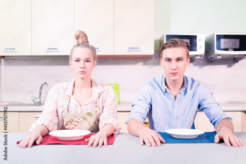 Fototapeta premium Young family with empty table in the kitchen. there