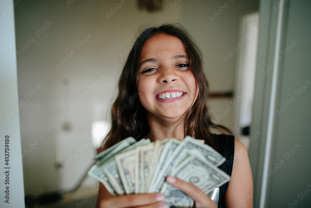 Portrait of cheerful girl with paper currency at home Portrait of cheerful girl with paper currency at home