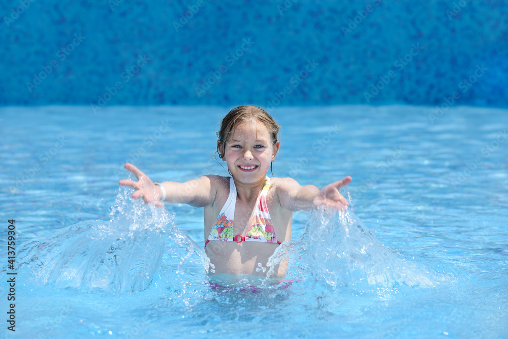 Little girl swimming at the pool
