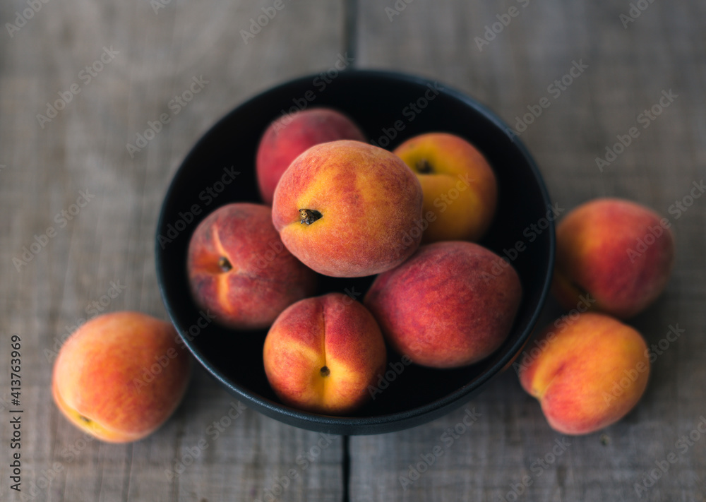 High angle view of peaches in bowl on wooden table High angle view of peaches in bowl on wooden table