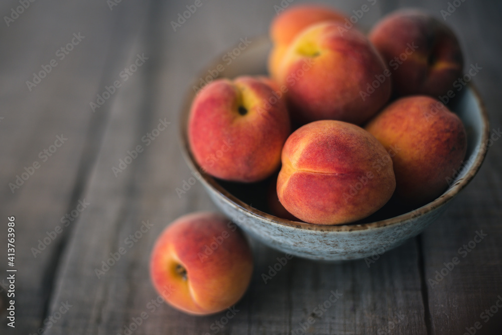 High angle view of peaches in bowl on wooden table High angle view of peaches in bowl on wooden table