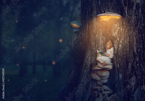 Enchanted forest - little girl sitting under the glowing mushroom, reading her b Fototapeta