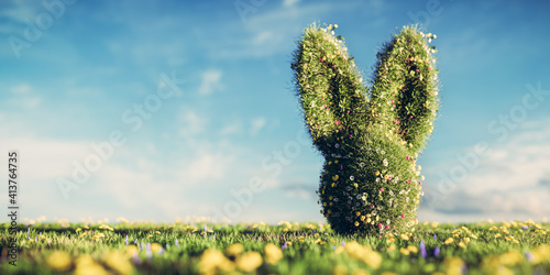 Fototapeta Naklejka Na Ścianę i Meble -  Easter bunny made of spring grass and flowers on green meadow.