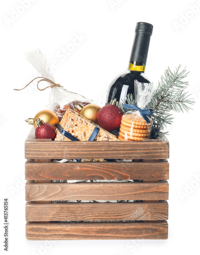 Gift basket with products and Christmas decor on white background