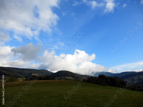 Beautiful summer mountains landscape with blue sky and green meadows