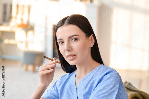 Young woman smoking cigaret...