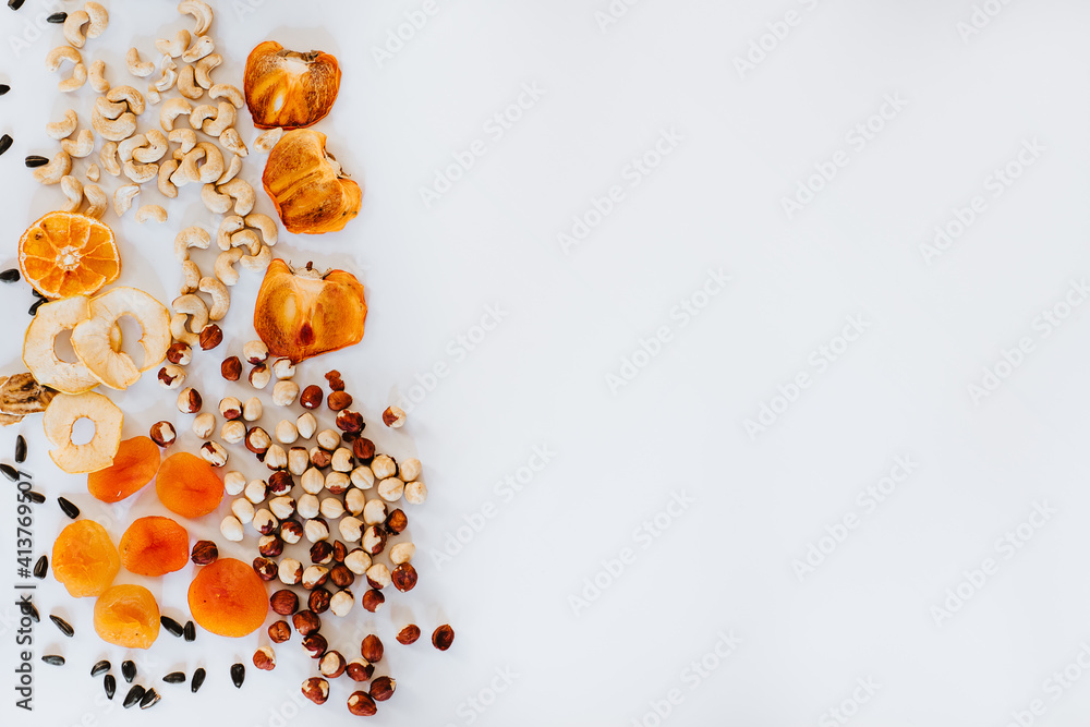 Top view of bunch of nuts and dried fruits on white background. Top view of bunch of nuts and dried fruits on white background.